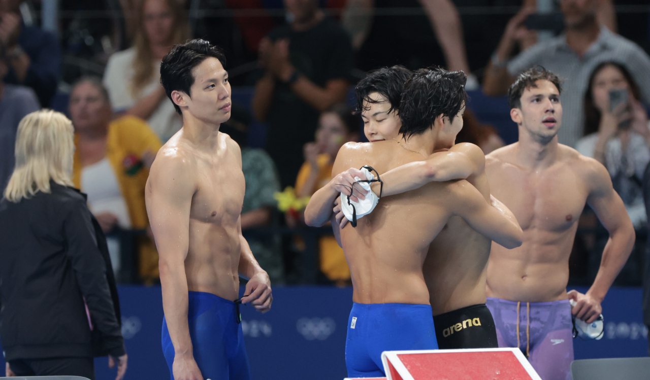 Yang Jae-hoon, Kim Woo-min and Lee Ho-joon (from left) of South Korea react to their sixth-place finish in the men's 4x200-meter freestyle relay final at the Paris Olympics at Paris La Defense Arena in Nanterre, France, on Tuesday. (Yonhap)